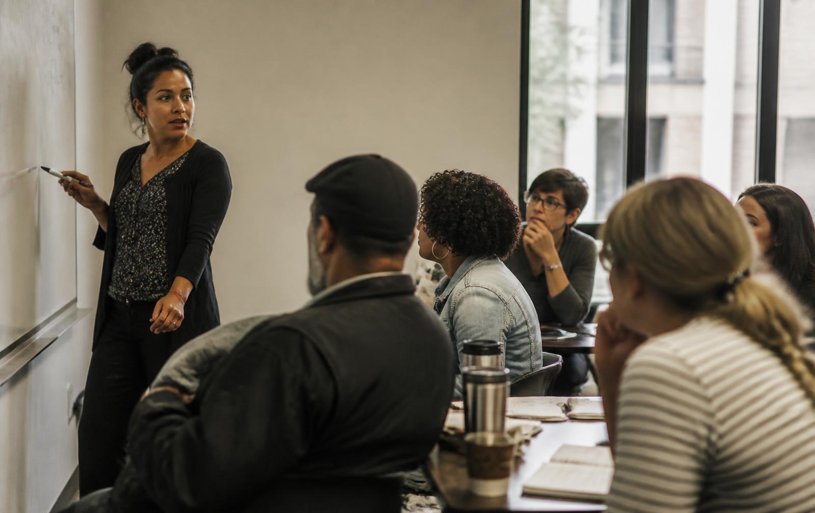 An educator leading a session with adult learners